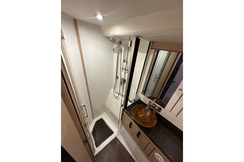 Slide: The Image of Bathroom interior of 2017 Jeanneau 64 yacht with shower and wooden sink. - 98