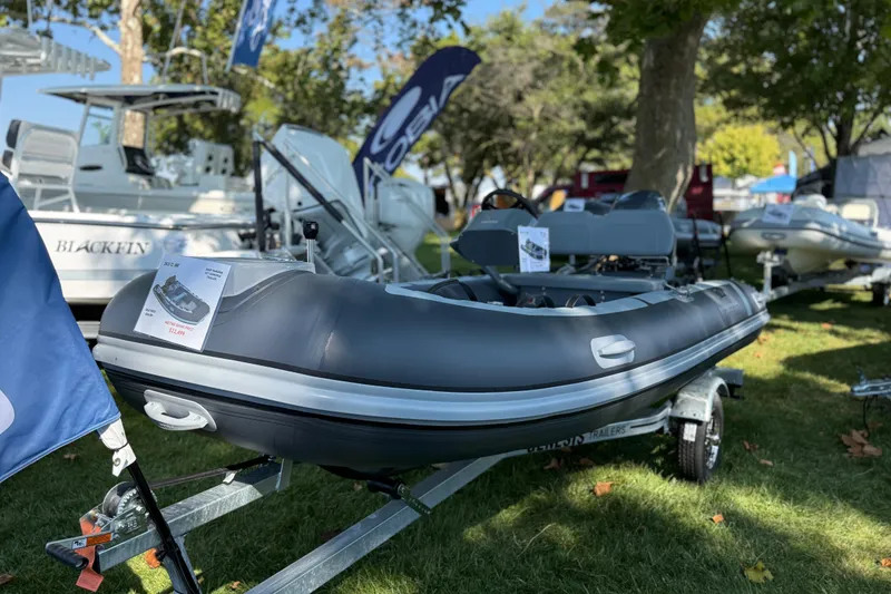 Slide: The Image of 2025 Highfield Classic 380 inflatable boat displayed outdoors on a trailer. - 5