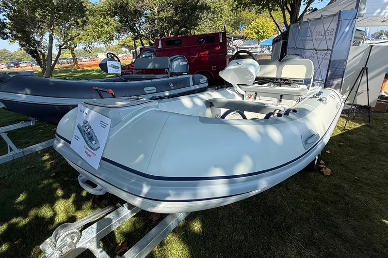 Slide: The Image of 2025 Highfield Classic 380 inflatable boat displayed outdoors on a trailer. - 1