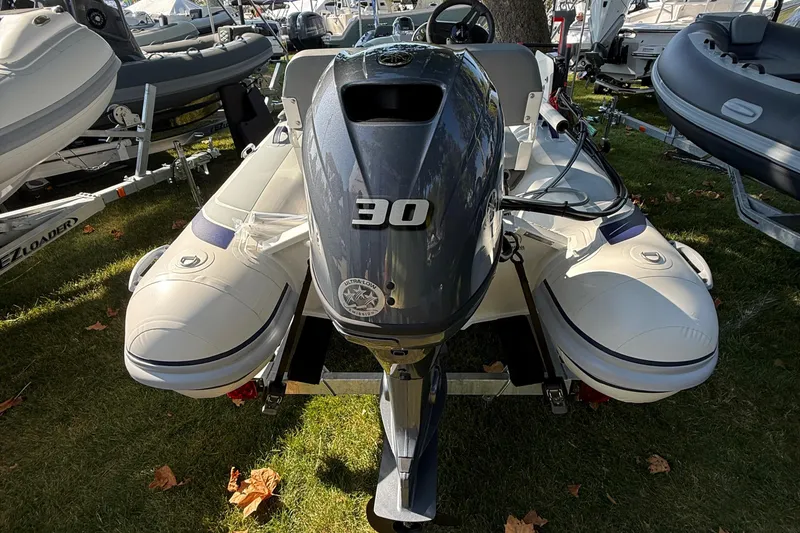 Slide: The Image of 2025 Highfield Classic 380 inflatable boat with 30 HP outboard motor on display. - 3