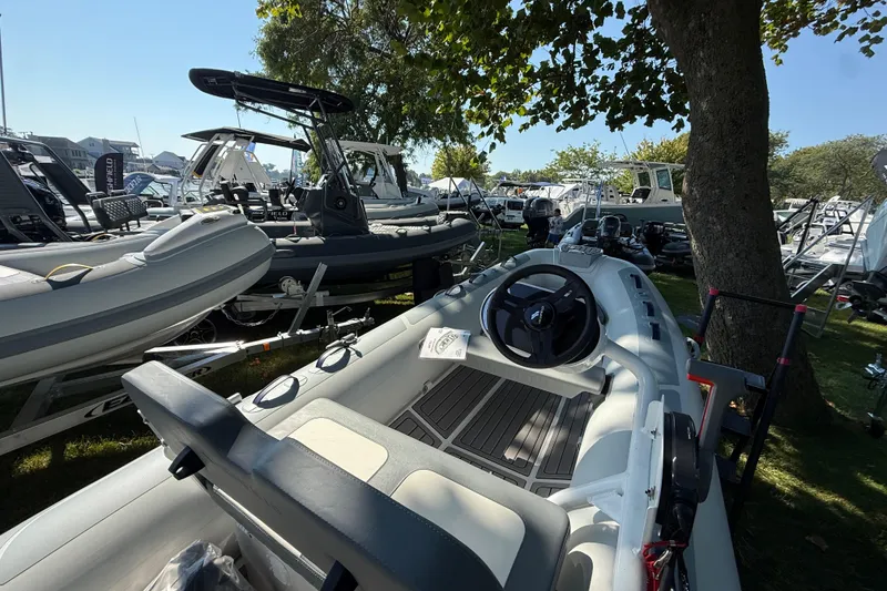 Slide: The Image of 2025 Highfield Classic 380 boat displayed outdoors among other boats. - 4