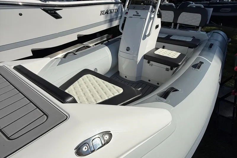 Slide: The Image of 2025 Highfield Sport 360 boat with sleek design and cushioned seating. - 2