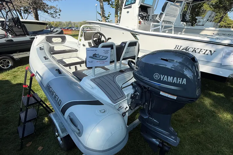 Slide: The Image of 2025 Highfield Sport 360 boat with Yamaha engine displayed outdoors. - 3