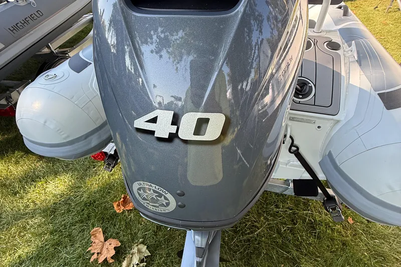 Slide: The Image of 2025 Highfield Sport 360 boat with 40 HP engine on grass. - 4