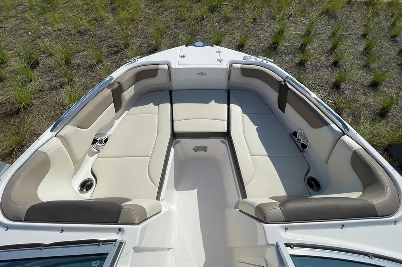 Slide: The Image of 2019 Chaparral 210 Suncoast boat interior with spacious seating and cup holders. - 11