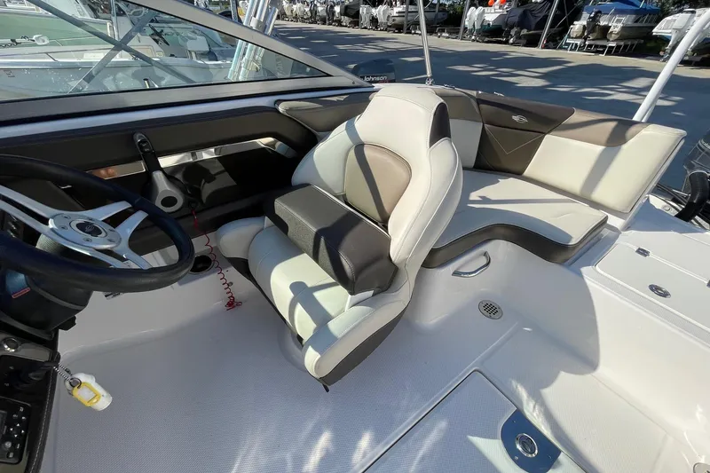 Slide: The Image of Interior of 2019 Chaparral 210 Suncoast boat, featuring steering wheel and seating area. - 14