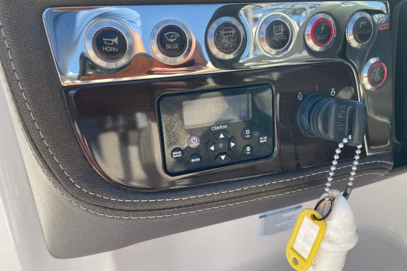 Slide: The Image of Control panel of a 2019 Chaparral 210 Suncoast boat with Clarion audio system. - 18