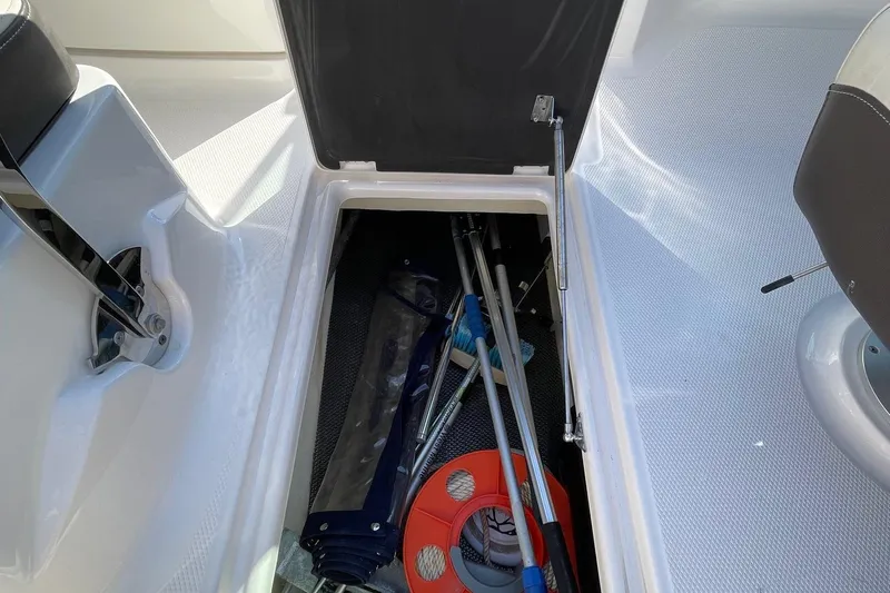 Slide: The Image of 2019 Chaparral 210 Suncoast boat storage compartment with equipment and accessories. - 33