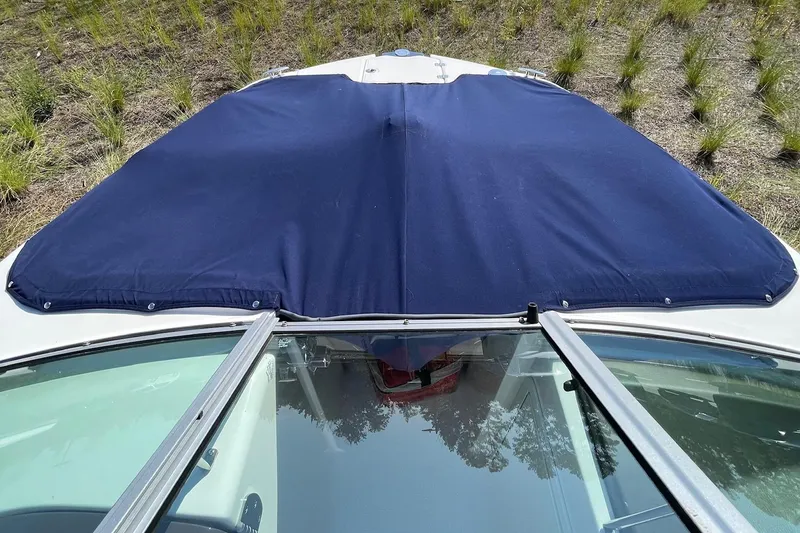 Slide: The Image of 2019 Chaparral 210 Suncoast boat with blue cover, viewed from above. - 37