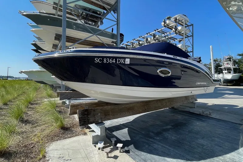 Slide: The Image of 2019 Chaparral 210 Suncoast boat in storage, side view, sunny day. - 4