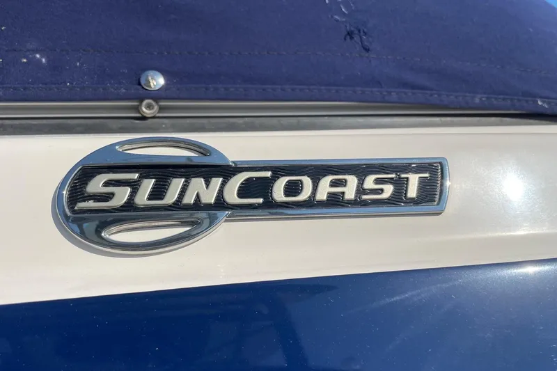 Slide: The Image of 2019 Chaparral 210 Suncoast boat emblem on blue and white surface. - 41