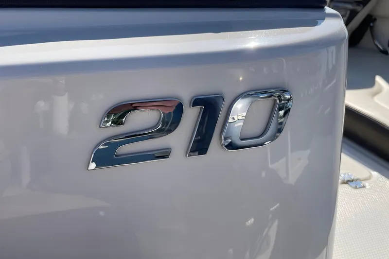 Slide: The Image of Chrome "210" emblem on 2019 Chaparral 210 Suncoast boat exterior. - 42