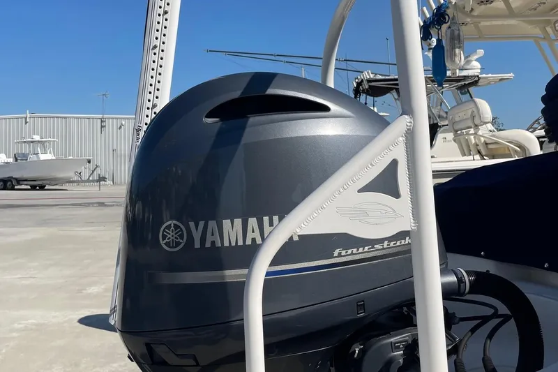 Slide: The Image of Yamaha four-stroke engine on 2019 Chaparral 210 Suncoast boat, docked outdoors. - 46