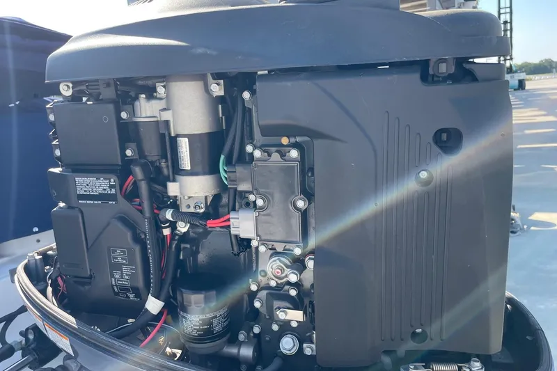 Slide: The Image of 2019 Chaparral 210 Suncoast engine close-up, showcasing mechanical components and wiring. - 49