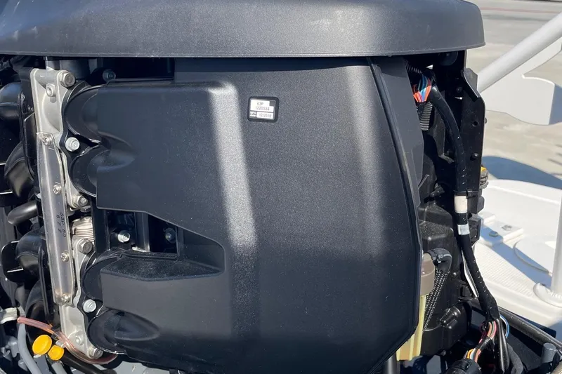 Slide: The Image of Close-up of a 2019 Chaparral 210 Suncoast boat engine, showcasing mechanical details. - 51