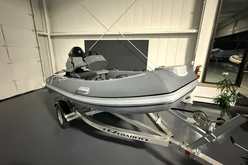 The Image of 2025 Highfield Classic 340 inflatable boat on trailer in showroom. - 0