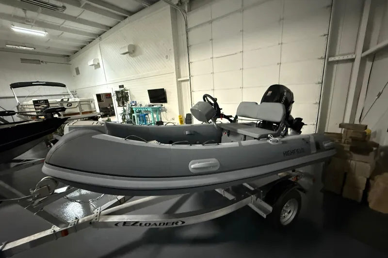 Slide: The Image of 2025 Highfield Classic 340 boat on trailer in indoor showroom. - 3