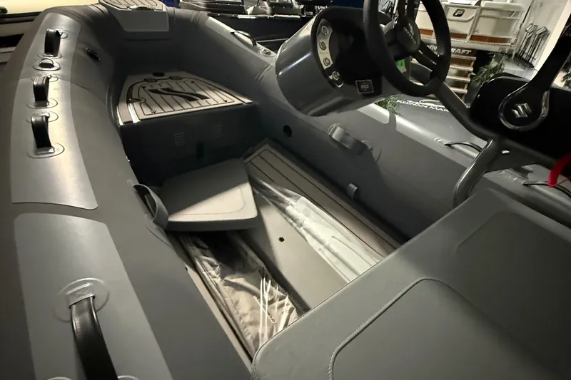 Slide: The Image of 2025 Highfield Classic 340 boat interior with steering wheel and seating. - 4