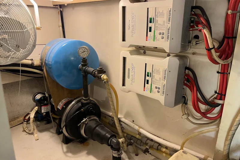 Slide: The Image of Engine room of 1997 Post Sportfish boat with water system and electrical components. - 17