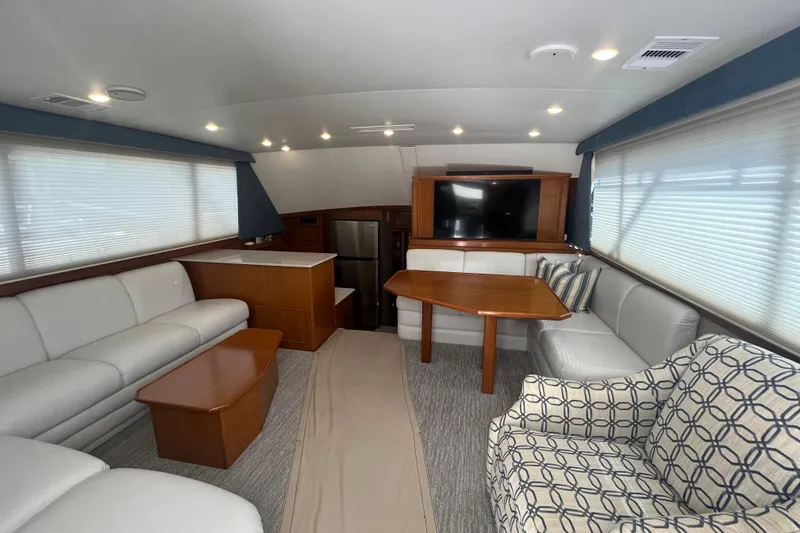 Slide: The Image of Luxurious 1997 Post Sportfish yacht interior with modern seating, table, and TV. - 21