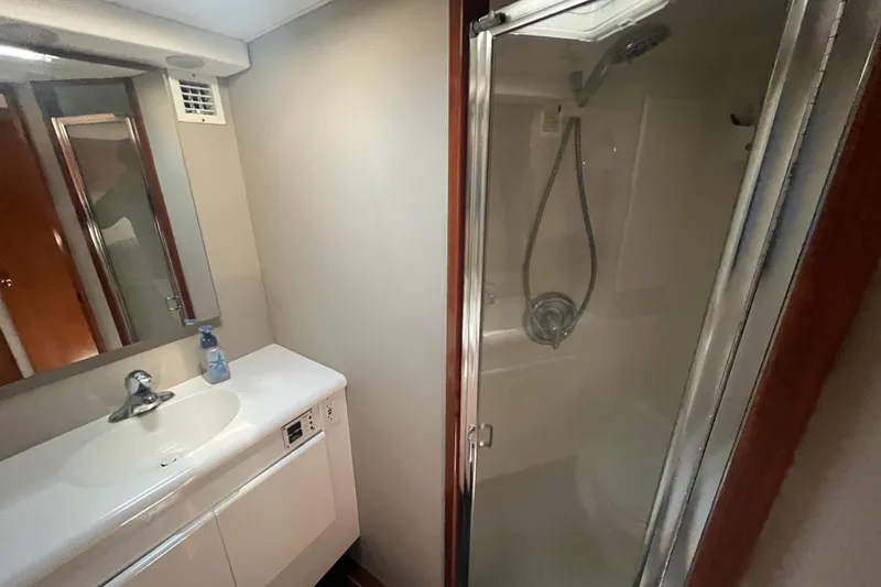 Slide: The Image of Bathroom interior of a 1997 Post Sportfish boat with shower and sink. - 37