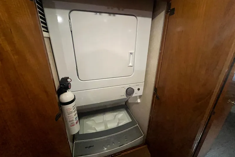 Slide: The Image of Stacked washer and dryer in 1997 Post Sportfish boat, with fire extinguisher nearby. - 38