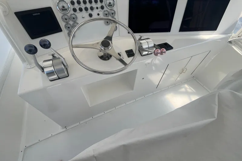 Slide: The Image of 1997 Post Sportfish boat helm with steering wheel, controls, and instrument panel. - 49