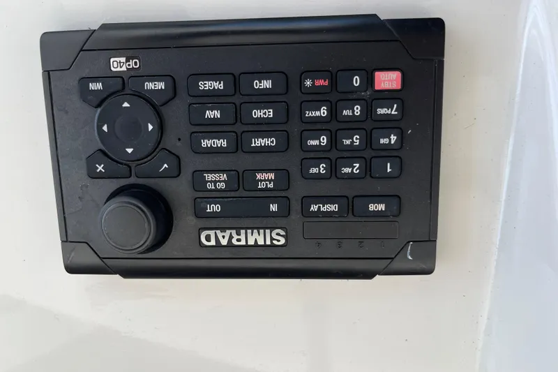Slide: The Image of Simrad marine control panel on a 1997 Post Sportfish boat. - 54