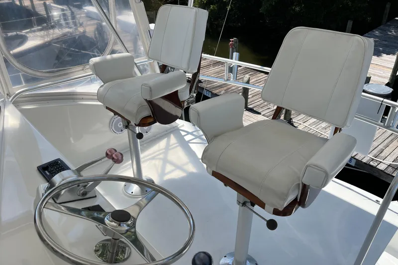 Slide: The Image of 1997 Post Sportfish helm with dual white captain chairs and steering wheel. - 57