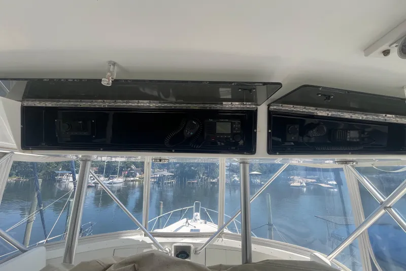 Slide: The Image of Interior view of 1997 Post Sportfish boat with navigation equipment and marina backdrop. - 60