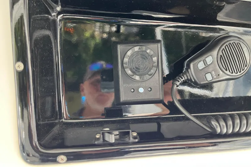 Slide: The Image of 1997 Post Sportfish boat control panel with microphone and remote control. - 64