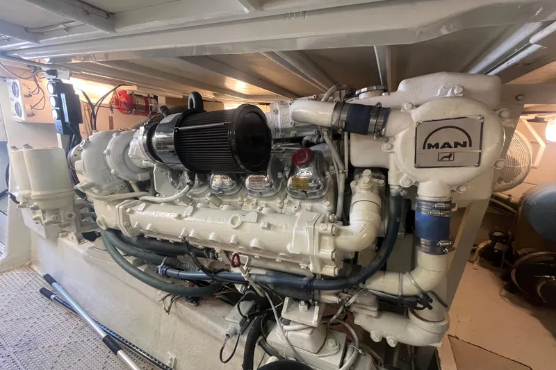 Slide: The Image of Engine room of a 1997 Post Sportfish boat featuring a MAN diesel engine. - 10