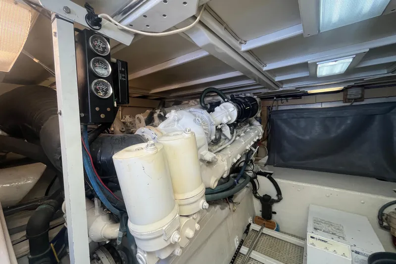 Slide: The Image of Engine room of a 1997 Post Sportfish boat, featuring gauges and mechanical components. - 11
