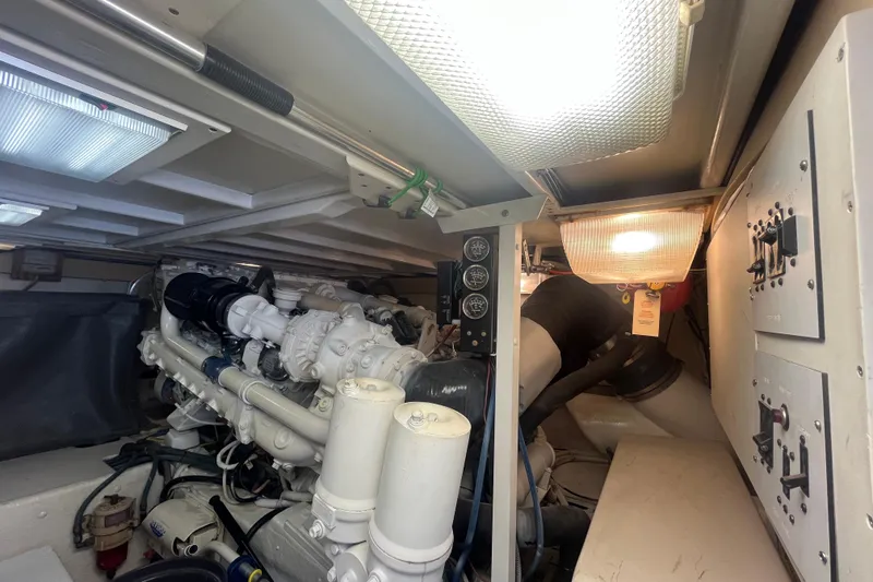 Slide: The Image of Engine room of a 1997 Post Sportfish boat, featuring mechanical components and control panels. - 12