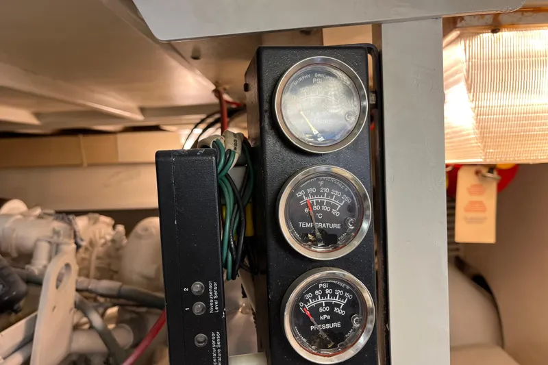 Slide: The Image of Control panel with gauges in a 1997 Post Sportfish boat engine room. - 14