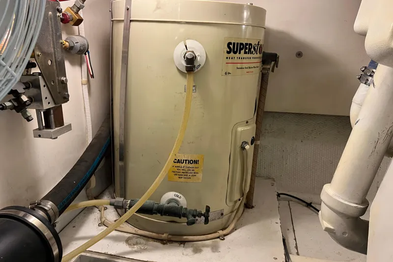 Slide: The Image of 1997 Post Sportfish engine room with SuperStor water heater and plumbing components. - 16