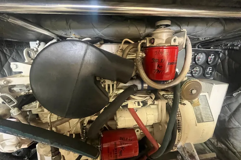 Slide: The Image of Engine compartment of a 1997 Post Sportfish boat, featuring filters and gauges. - 18