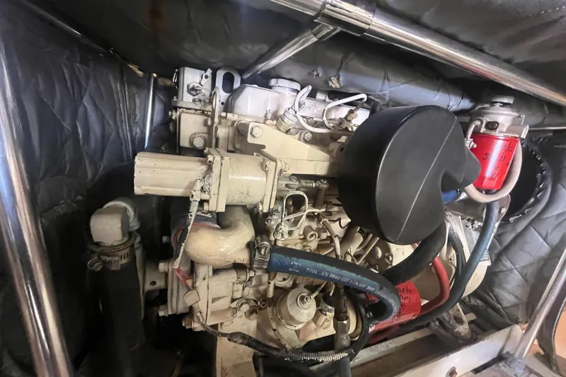 Slide: The Image of Engine compartment of a 1997 Post Sportfish boat, featuring mechanical components and hoses. - 19
