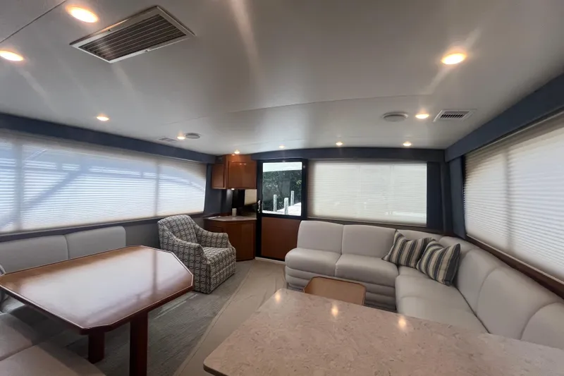 Slide: The Image of Luxurious interior of a 1997 Post Sportfish yacht with modern seating and dining area. - 23