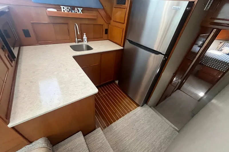 Slide: The Image of 1997 Post Sportfish yacht kitchen with modern appliances, wooden cabinetry, and cozy interior design. - 26