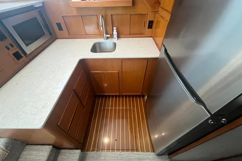 Slide: The Image of 1997 Post Sportfish kitchen with stainless steel appliances and wooden cabinetry. - 27