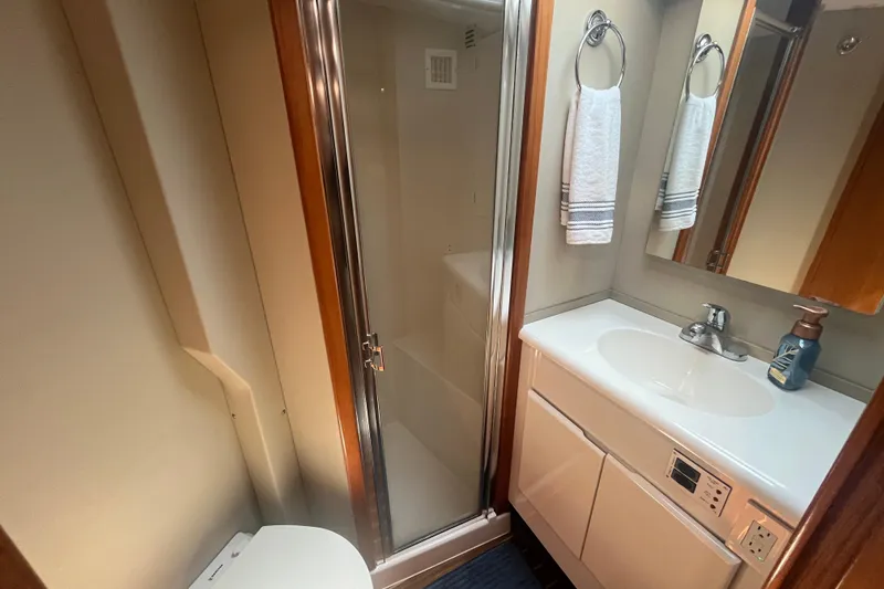 Slide: The Image of 1997 Post Sportfish bathroom with shower, sink, and mirror in compact marine design. - 30
