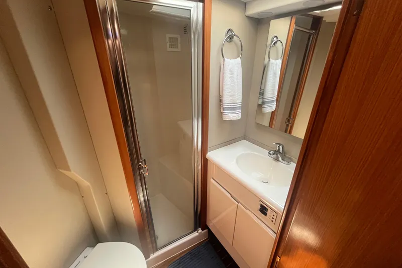 Slide: The Image of Bathroom interior of 1997 Post Sportfish yacht with shower, sink, and mirror. - 31
