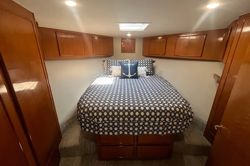 Slide: The Image of 1997 Post Sportfish cabin with nautical-themed bedding and wooden cabinetry. - 34