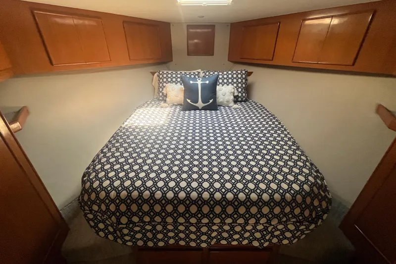 Slide: The Image of Cozy cabin bedroom in 1997 Post Sportfish boat with nautical-themed bedding. - 35