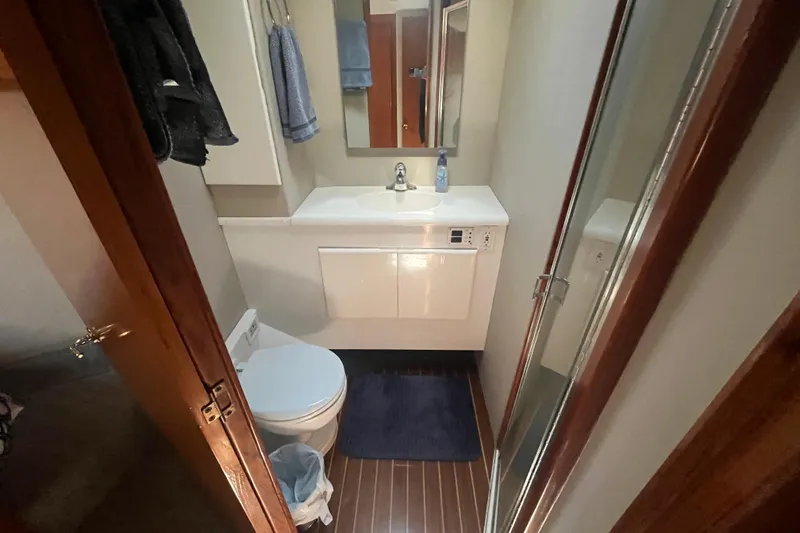 Slide: The Image of Bathroom interior of 1997 Post Sportfish boat with sink, toilet, and shower. - 36
