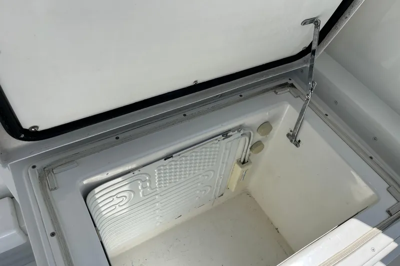 Slide: The Image of Open storage compartment on a 1997 Post Sportfish boat, featuring a clean interior. - 43
