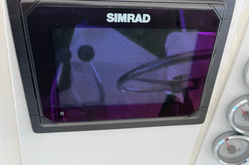 Slide: The Image of Simrad display on 1997 Post Sportfish boat dashboard with gauges visible. - 50
