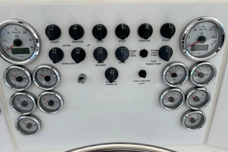 Slide: The Image of Control panel of a 1997 Post Sportfish boat with gauges and switches. - 51