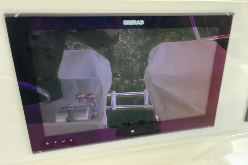 Slide: The Image of Simrad display on 1997 Post Sportfish boat, showing covered controls and railing. - 52